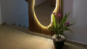 A hallway with a decorative wooden door featuring a heart-shaped mirror. - house with a beautiful sea view in enchanting SurfCity with WiFi, AC and Pool. (La Libertad)
