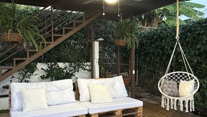A covered outdoor seating area with a wooden bench and a cushioned bench with pillows, under a wooden ceiling structure. - house with a beautiful sea view in enchanting SurfCity with WiFi, AC and Pool. (La Libertad)