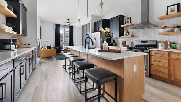 A modern kitchen with a large island, bar stools, and pendant lighting. - The Bluestem - Stylish Design, Rooftop w/ Firepit! (Nashville)