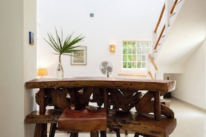 Enjoy a warm and inviting dining experience in this cozy space with a rustic table and matching chairs.