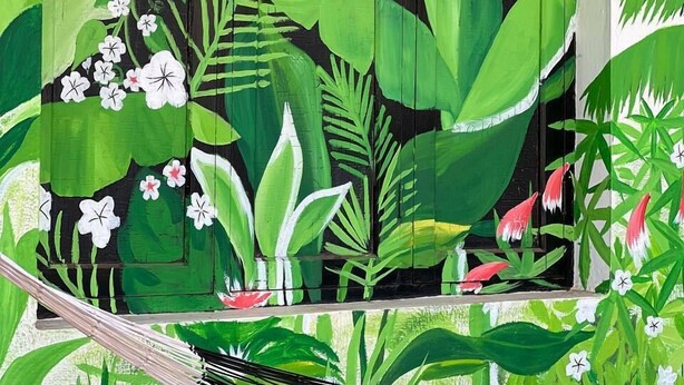 A mural with tropical plants and the text "The Chill House" on a black door. - The Chill House (Kochi)
