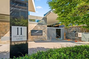 A modern building with a sign for 'Lakefront Kingston Island' and 'Capital Building Remediation.'