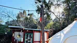 A rustic cabin with a small porch, a tent, and a wooden deck. - Cozy Yurt in perfect Austin with AC, Free Wifi, free Parking & jacuzzi use (Austin)