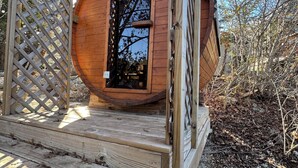 A wooden cabin with a circular door, a wooden deck, and a lattice fence. - Cozy Yurt in perfect Austin with AC, Free Wifi, free Parking & jacuzzi use (Austin)
