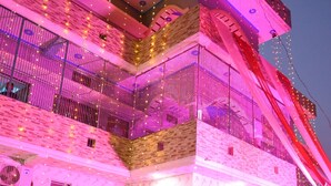 A multi-story building with balconies, a staircase, and outdoor seating. - Shri Sita Vallabh Padchhaya (Ayodhya)