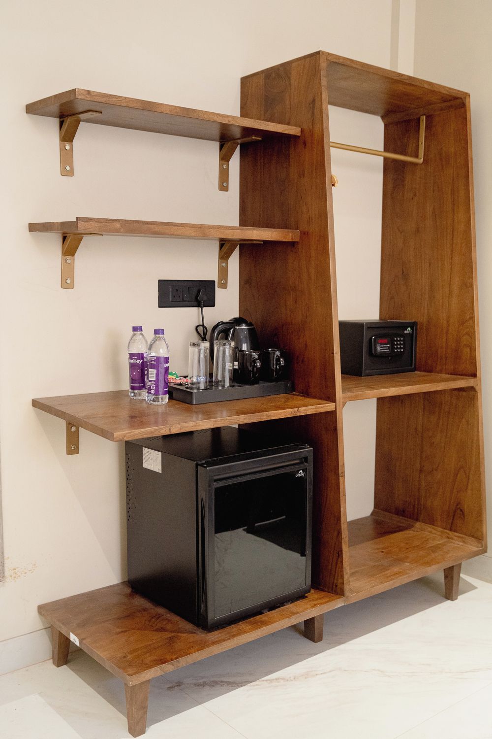 A compact kitchenette with a built-in refrigerator, a coffee maker, and a microwave.