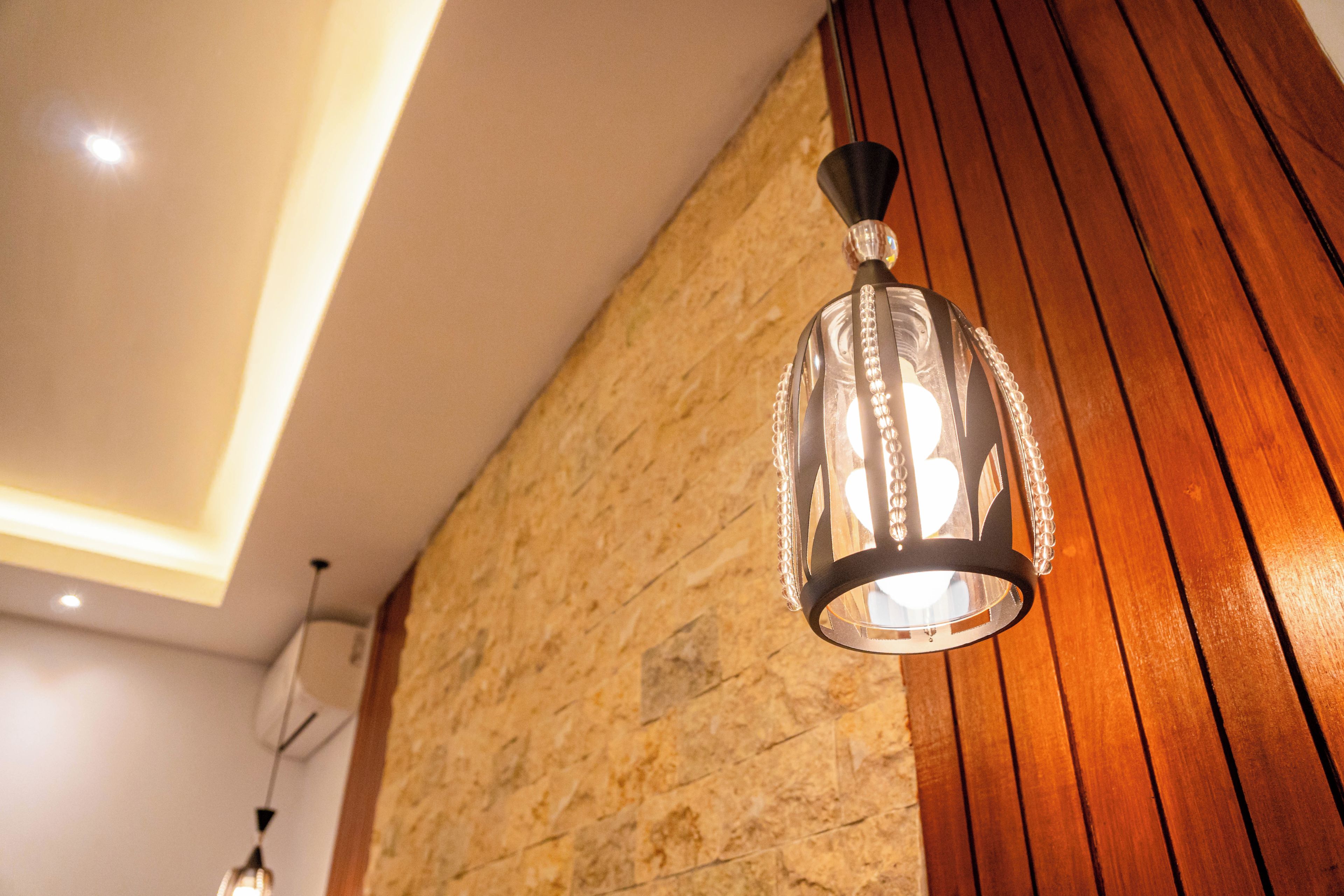 A modern interior with a stone wall and wooden paneling.