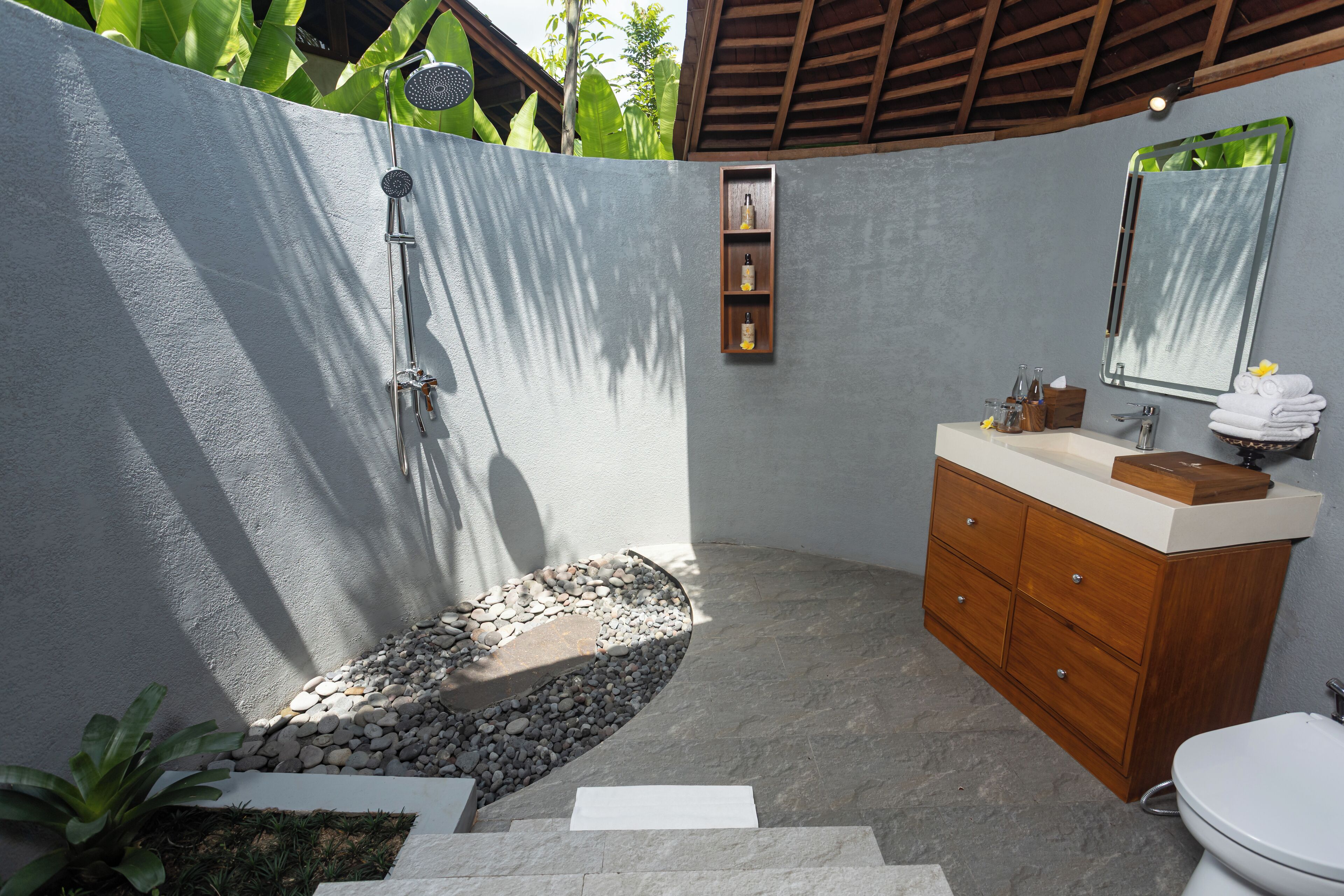 A bathroom with a shower, sink, and toilet.