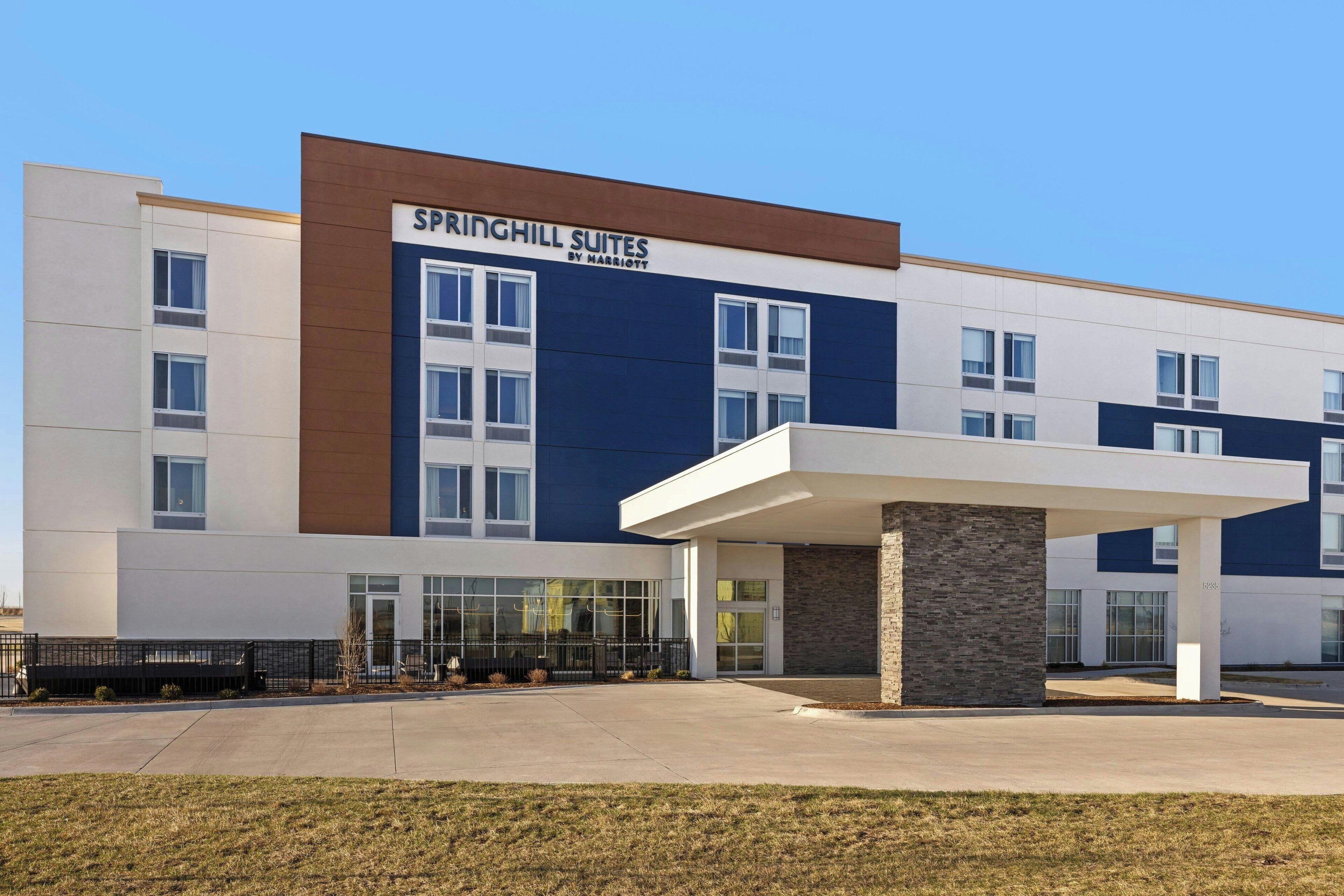 A modern hotel with a sign reading "SPRINGHILL SUITES BY HARRIOT".