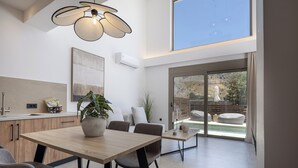 A modern kitchen with a dining area, large windows, and a view of the outdoors. - Imbros Villa 1 Free* Heated Pool & Tranquility! (Crete)