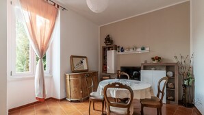 A dining area with a table, chairs, a cabinet, and a fireplace. - GuestHost - Accommodation of 90 sqm on the first floor of a building with elevator, about 10 steps to access (NOT suitable for disabled), ideal for 4 guests.Located in a strategic position two passes from the Vatican and the Sala Nervi, just steps from S (Roma)