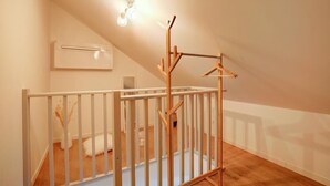 A room with a white crib, a wooden play structure, a white radiator, and a ceiling light fixture. - Le Villandry beautiful apartment (Tours)