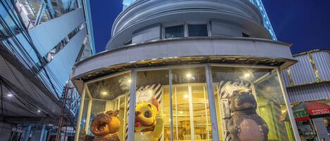 Un edificio con fachada de vidrio que exhibe esculturas de animales de gran tamaño.