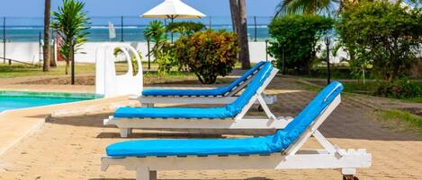 A poolside area with lounge chairs and a small pool.