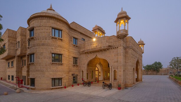 A historic building with a grand entrance, multiple windows, and a prominent tower with lights. - Zone Connect by The Park Jaisalmer (Jaisalmer)