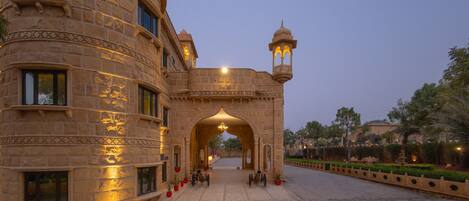 A historic building with an ornate archway and a traditional lantern.