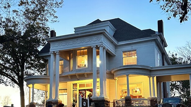 A large, two-story house with a wrap-around porch and multiple windows. - The Judge's Chambers (Guthrie)