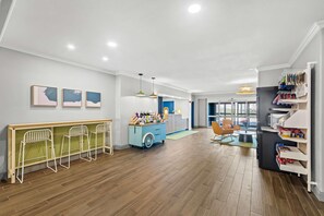 A modern interior with a bar area, seating, and a kitchen. - Spark by Hilton Killeen (Killeen)