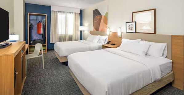 A hotel room with two beds, a desk, a chair, a wardrobe, and a window with curtains. - Spark by Hilton Killeen (Killeen)