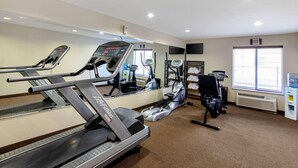 A gym with treadmills, an elliptical, and a stationary bike. - Spark by Hilton Killeen (Killeen)