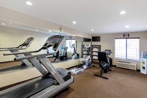 A gym with treadmills, an elliptical, and a stationary bike.