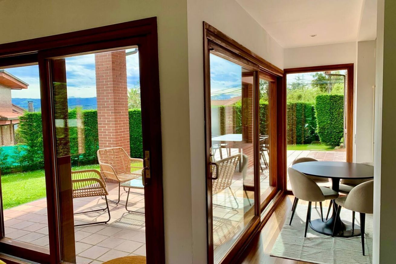 A room with a sliding glass door leading to a patio with outdoor furniture.