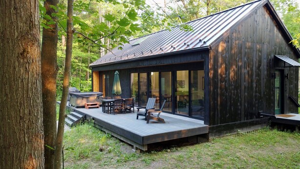 A cabin with a deck, outdoor seating, and a hot tub. - Scandinavian Chalet | Games | Hot Tub/Sauna (Dansville)
