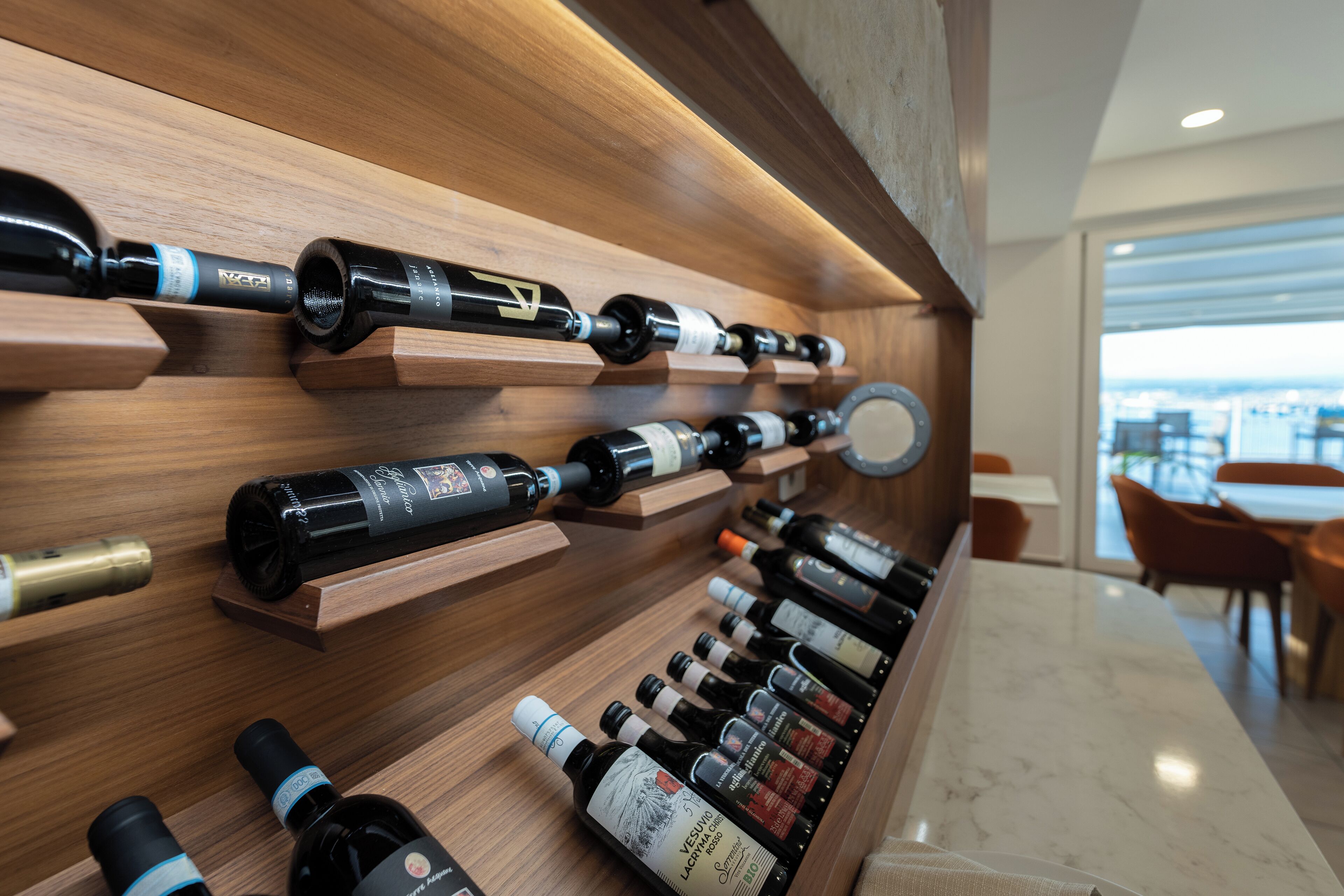 A wine rack with bottles and a marble countertop.