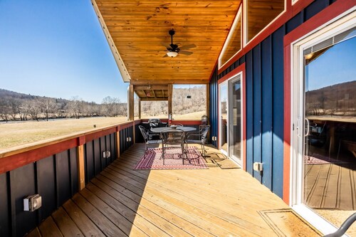 Charming riverside with stunning views, cozy interiors, full amenities, and spacious decks.