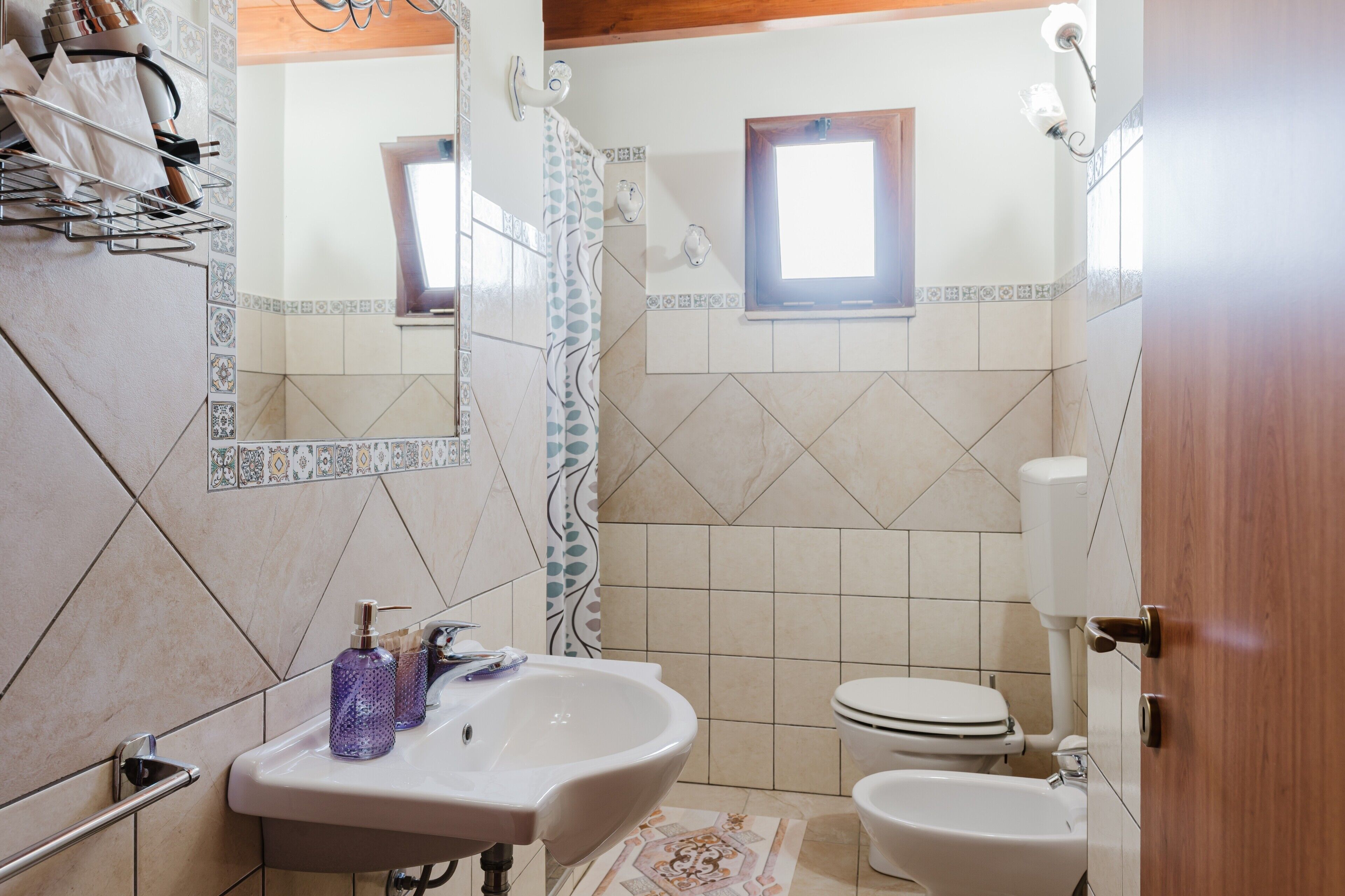 A bathroom with a sink, toilet, and shower.