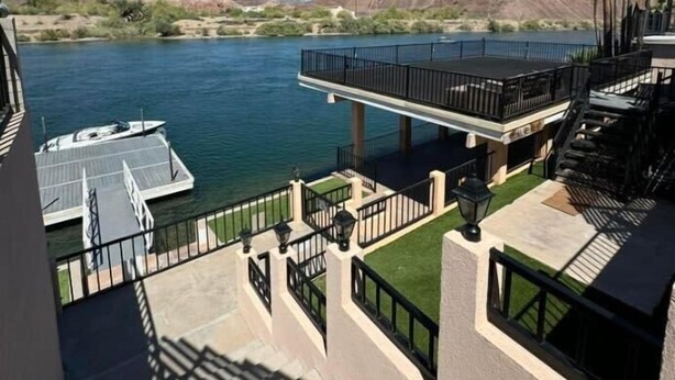 A waterfront property with a dock, a balcony with a railing, and a view of the river and hills. - Cliff Hanger, River access with dock (Parker)