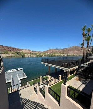 A waterfront property with a dock, a balcony with a railing, and a view of the river and hills. - Cliff Hanger, River access with dock (Parker)
