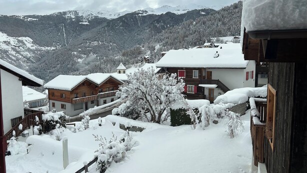 A snowy mountain village with wooden houses and a view of snow-covered mountains in the background. - HAUTE-NENDAZ VILLAGE: LARCH 1898 4-STOREY/4-ROOM/6-PERSON CHALET/PARKING. (Nendaz)