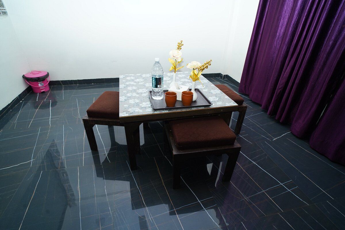 A small dining area with a table, chairs, and a water bottle.
