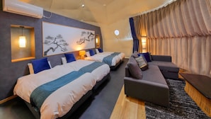 A modern hotel room with two beds, a sofa, a wall-mounted air conditioner, and a large painting. - Mt.Fuji Glamping Terrace MINENOHANA (Fujikawaguchiko)