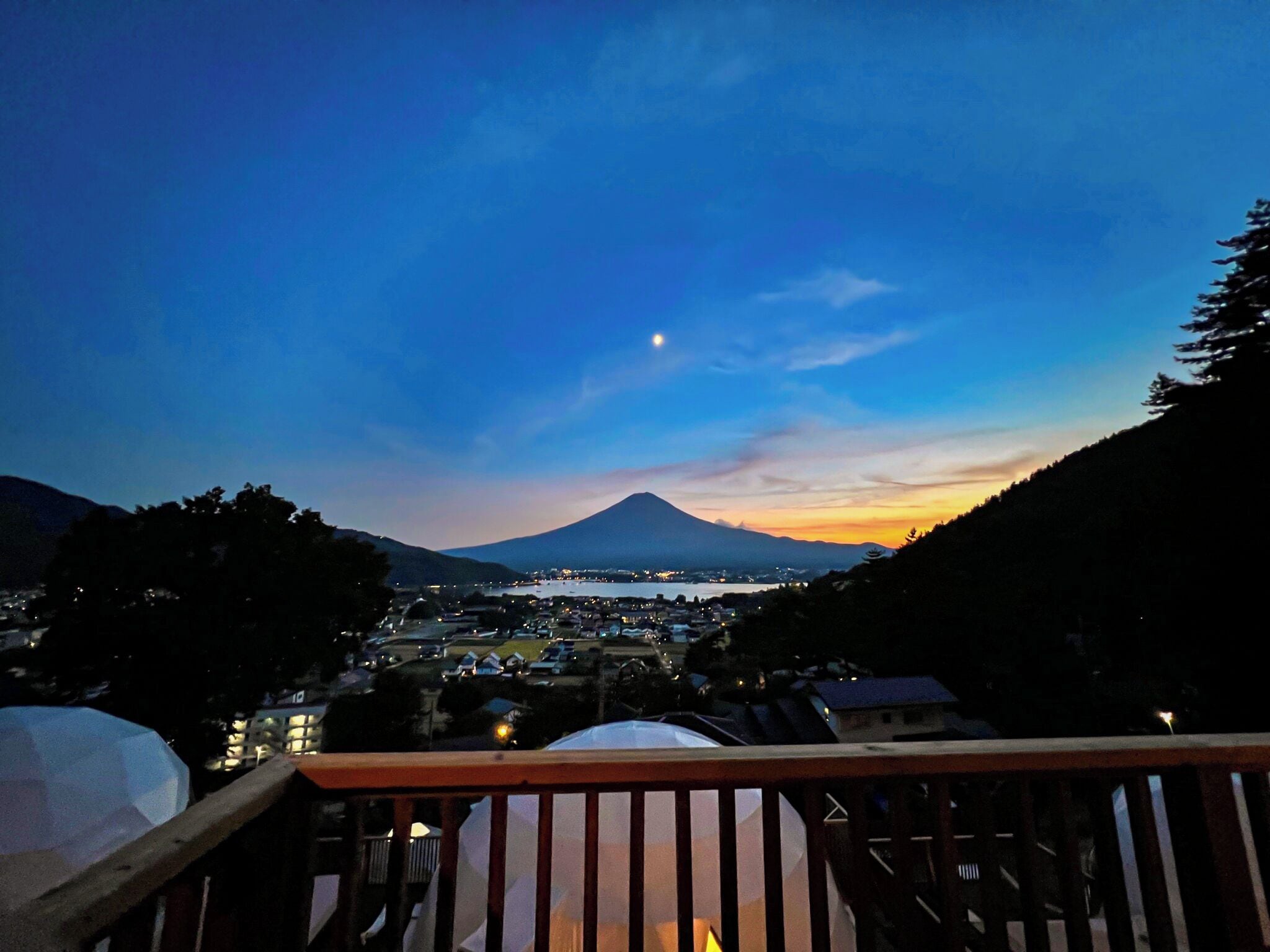 A night view of a town with a mountain in the background.