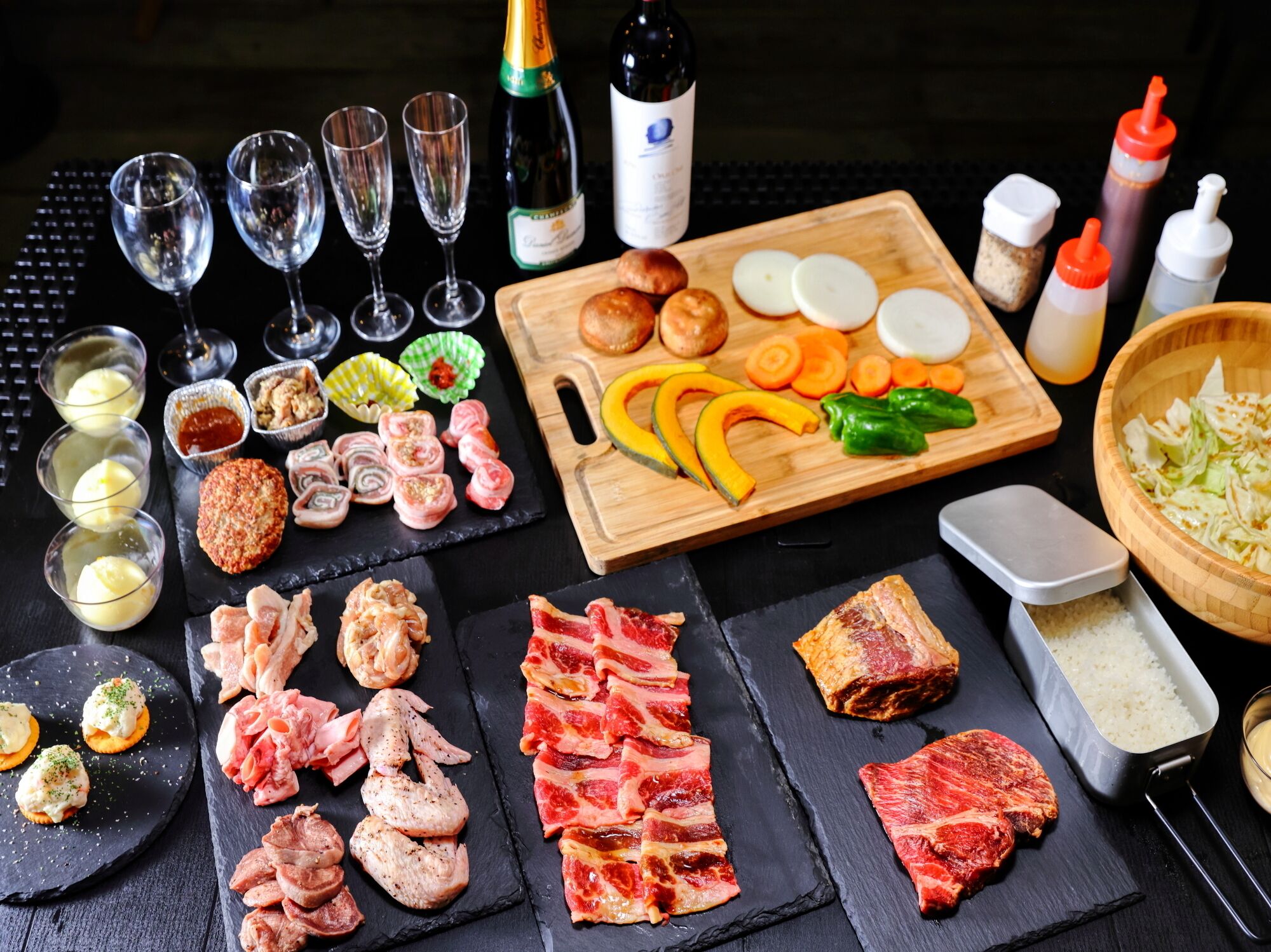 A variety of food items including meats, vegetables, and condiments arranged on a table.