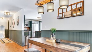 A modern kitchen with a large wooden island, stainless steel appliances, and pendant lighting. - Forested Retreat w/ Sauna: 5 Mi to Schroon Lake (Schroon Lake)