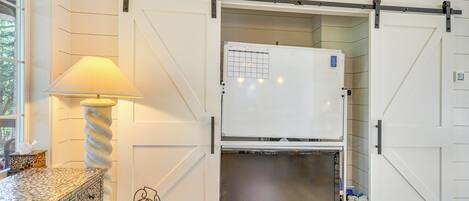 A kitchen with a white refrigerator, a built-in oven, and a sliding door.