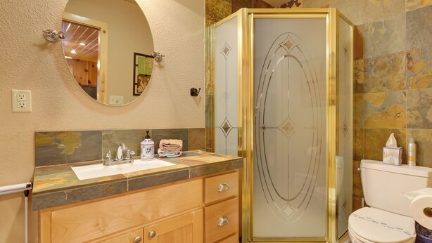A bathroom with a wooden vanity, a glass shower enclosure, and a toilet. - 5 Mi to Dodge Ridge: Cabin in Strawberry (Strawberry)