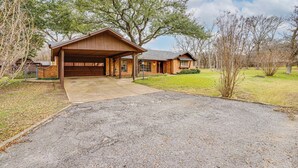 A two-story house with a garage and a covered driveway. - Karaoke Ready! Fort Worth Area Home (Aledo)