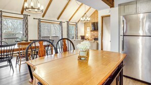 A spacious kitchen with a large stainless steel refrigerator, wooden dining table, and chairs. - Walk to Hideout Slopes: Home w/ Game Room! (Lake Ariel)