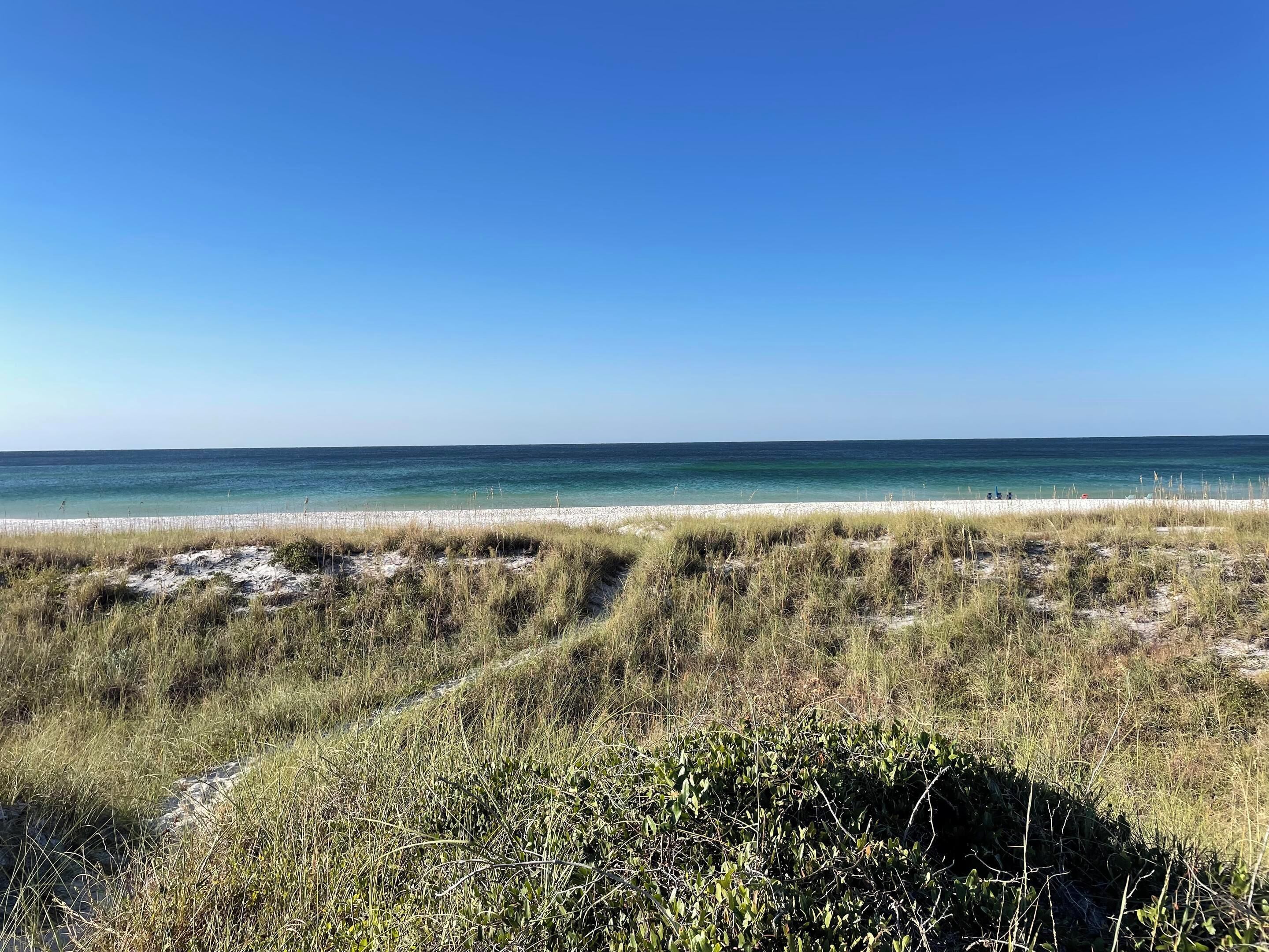 A beach with clear skies and calm waters.