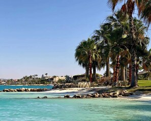 On the beach, sun-loungers, beach towels - New! Luxury Marina Resort Chalet: Panoramic Rixos & New Alamein Tower Views (Marina El Alamein)