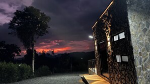 A stone building with a paved entrance and a view of the sky.