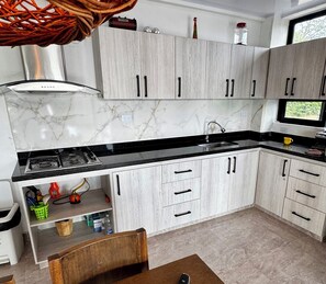 Fridge, coffee/tea maker, blender, cookware/dishes/utensils