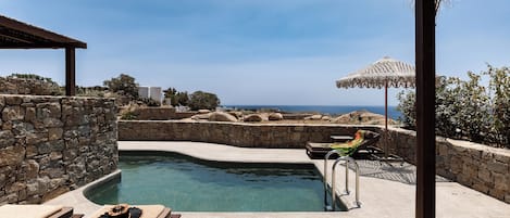 Seasonal outdoor pool, open 10:00 AM to 6:00 PM, pool umbrellas