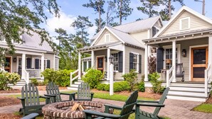 A row of cabins with a fire pit and outdoor seating.