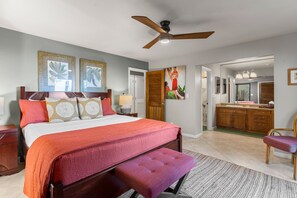 A bedroom with a bed, a ceiling fan, and artwork on the wall. - Maui Kamaole, #a-106 1 Bedroom Condo (Kihei)