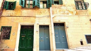 A building with three doors, each with a different design.